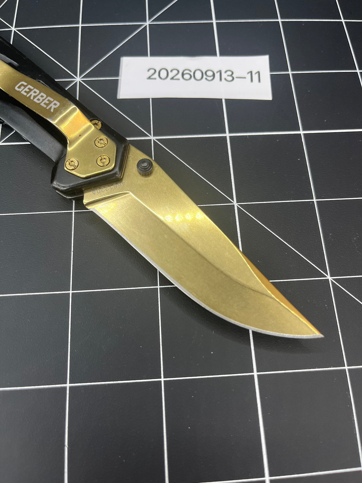 Gerber Paralite folding pocket knife with a gold-toned/bronze titanium nitride coating