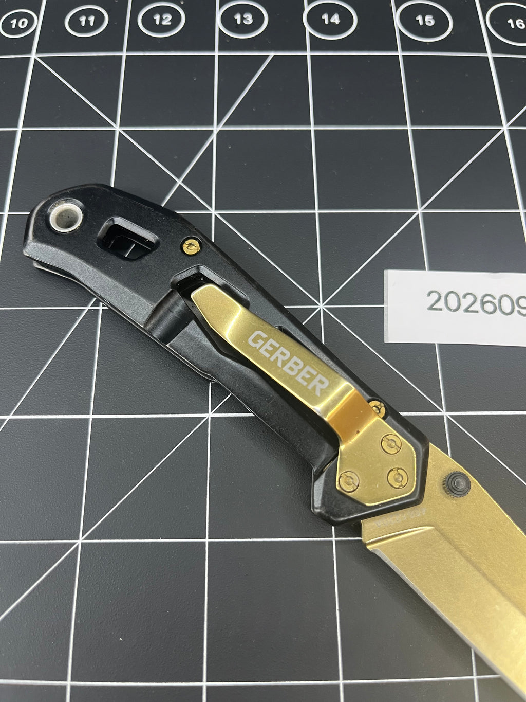 Gerber Paralite folding pocket knife with a gold-toned/bronze titanium nitride coating